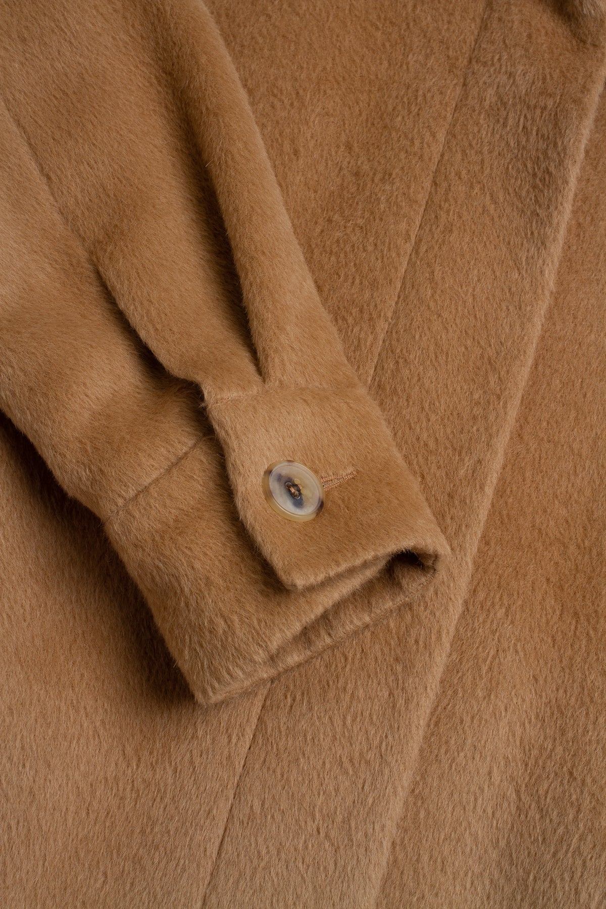 Close-up of a brown textured fabric with a button