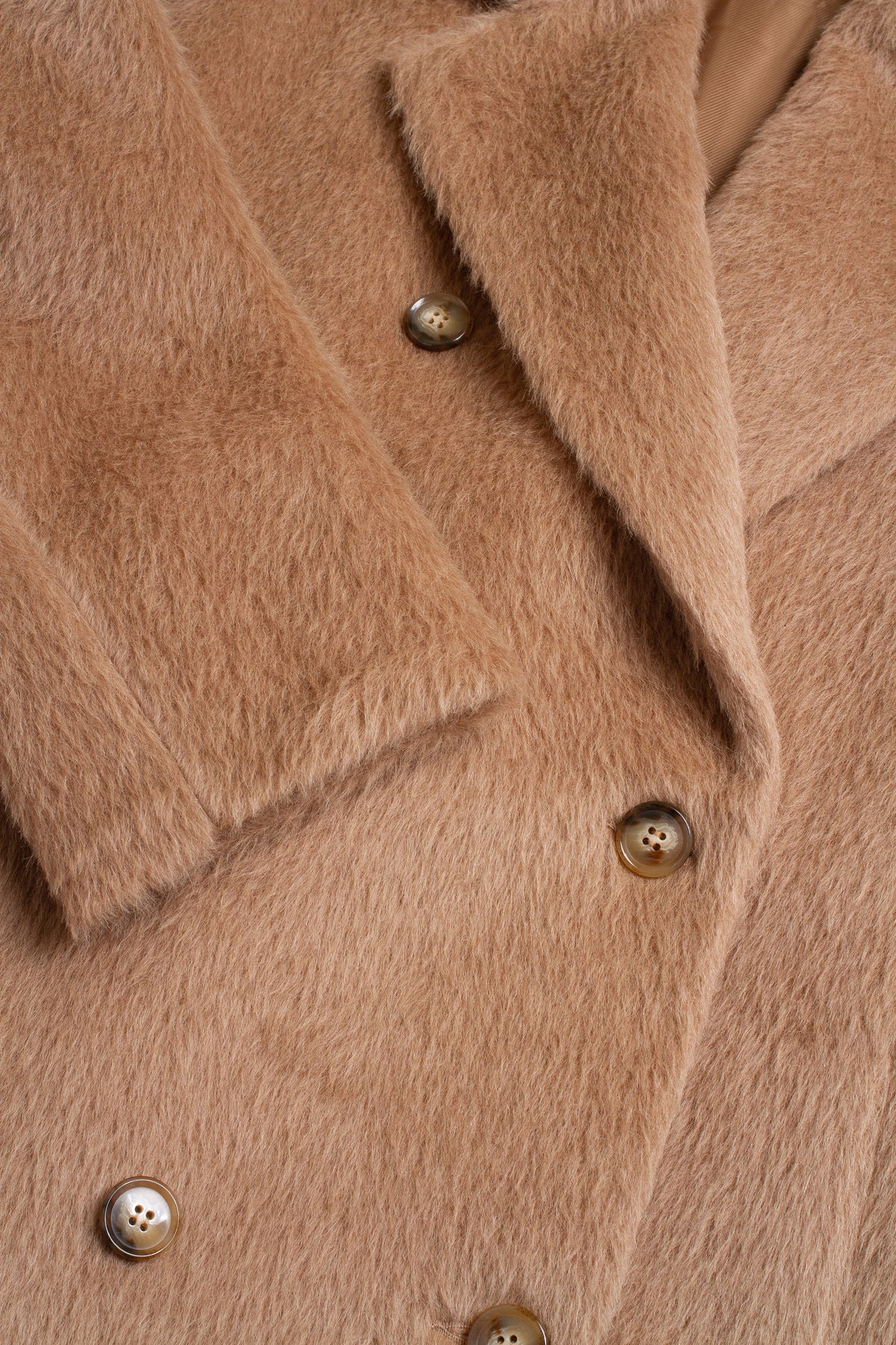 Close-up of a brown coat with buttons