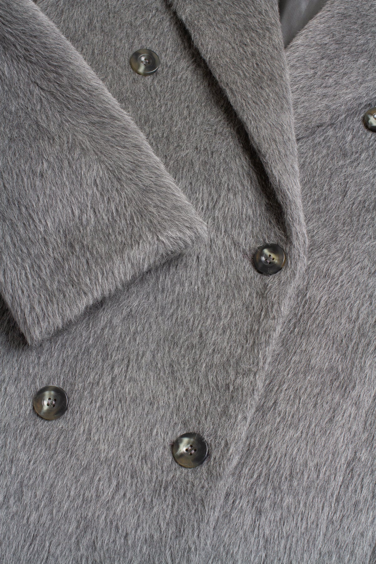 Close-up of a gray coat with buttons